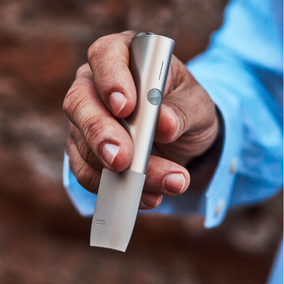 An IQOS ILUMA device and mobile phone.