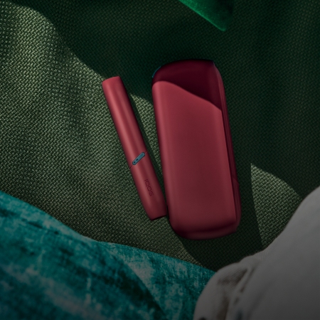 Red IQOS Originals Duo heated tobacco holder and pocket charger.